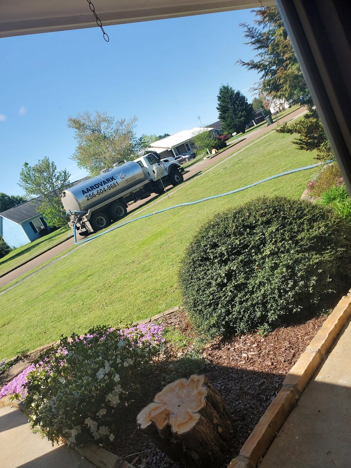 The branded Aardvark vacuum truck lettered with the phone number, parked at a job